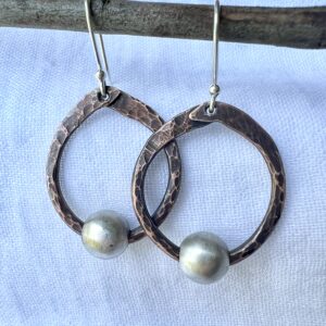 Hand hammered round copper earrings with sterling silver bead